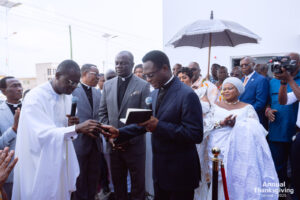 Dr. Joseph Siaw Agyapong handling the church key to the Chairman of the Pentecost, Apostle Eric Nyamekye